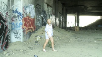 Stray blonde sexy girl pissing in some forgotten palce